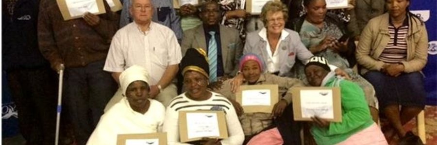 Minister Madikizela and Executive Mayor Nicolette Botha-Guthrie flanked by Councillors, the Deputy Mayor and beneficiaries during the hand-over of 183 title deeds.